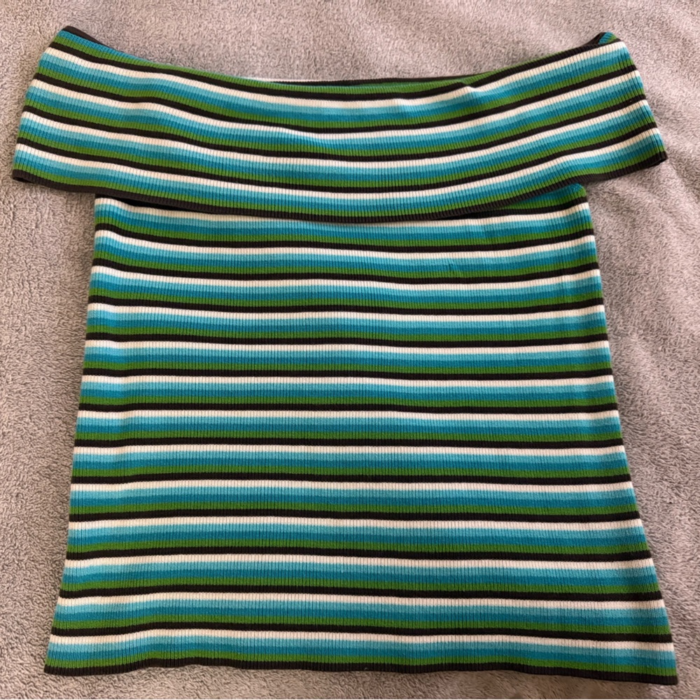 White and green off shoulder shirt.